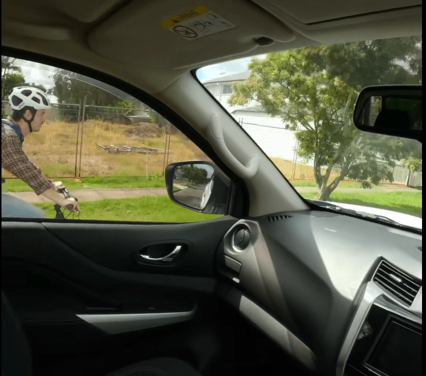 view from a driver with a bike rider just outside