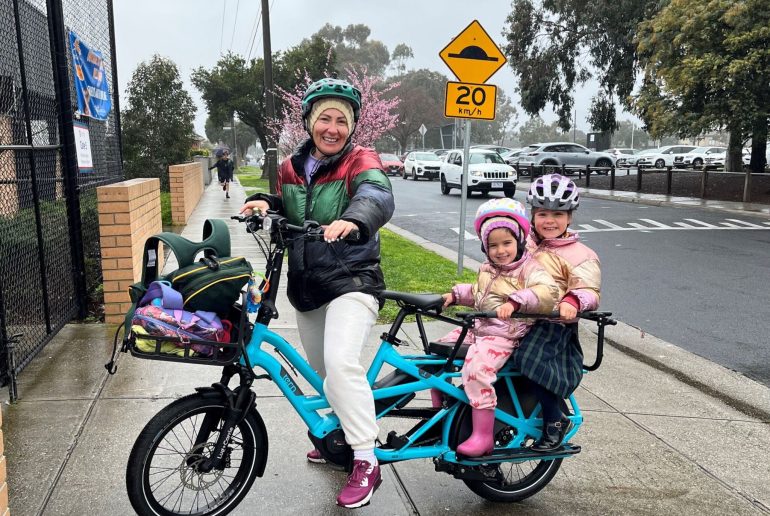 mum with kids on bikes in the street