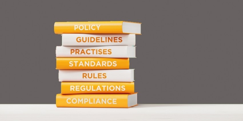 books stack of policy, legislation, guidelines